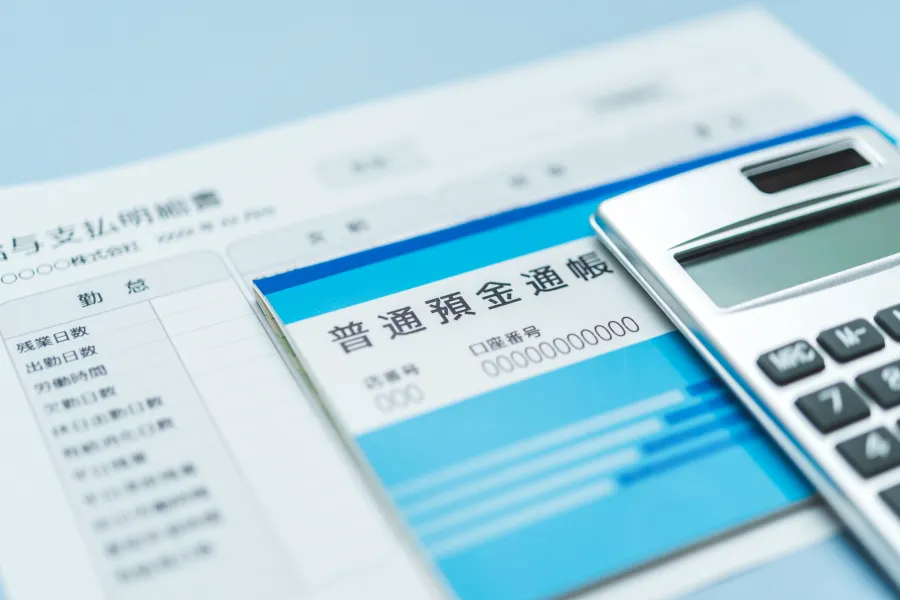 給与明細と預金通帳で養育費の金額や支払方法を検討するイメージ